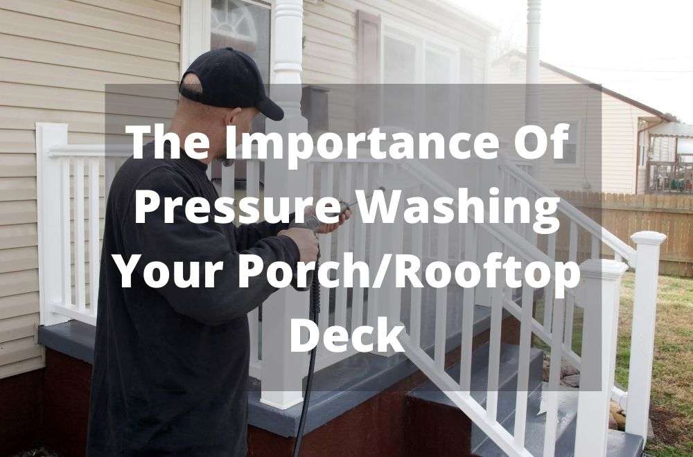 Man in a baseball cap pressure washing a porch with the text "The Importance Of Pressure Washing Your Porch/Rooftop Deck" overlaying the photo.