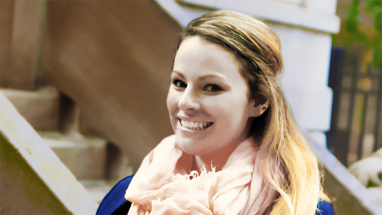 Happy woman with a pink scarf and blue jacket in front of a Composite Decking Chicago project.